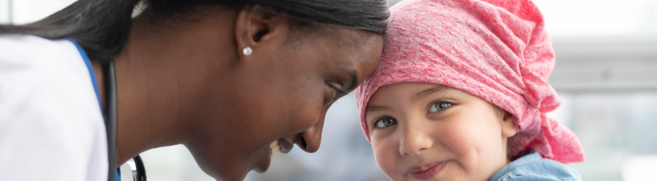 A doctor and a girl in a pink headscarf showcasing a moment of tenderness and connection between them.