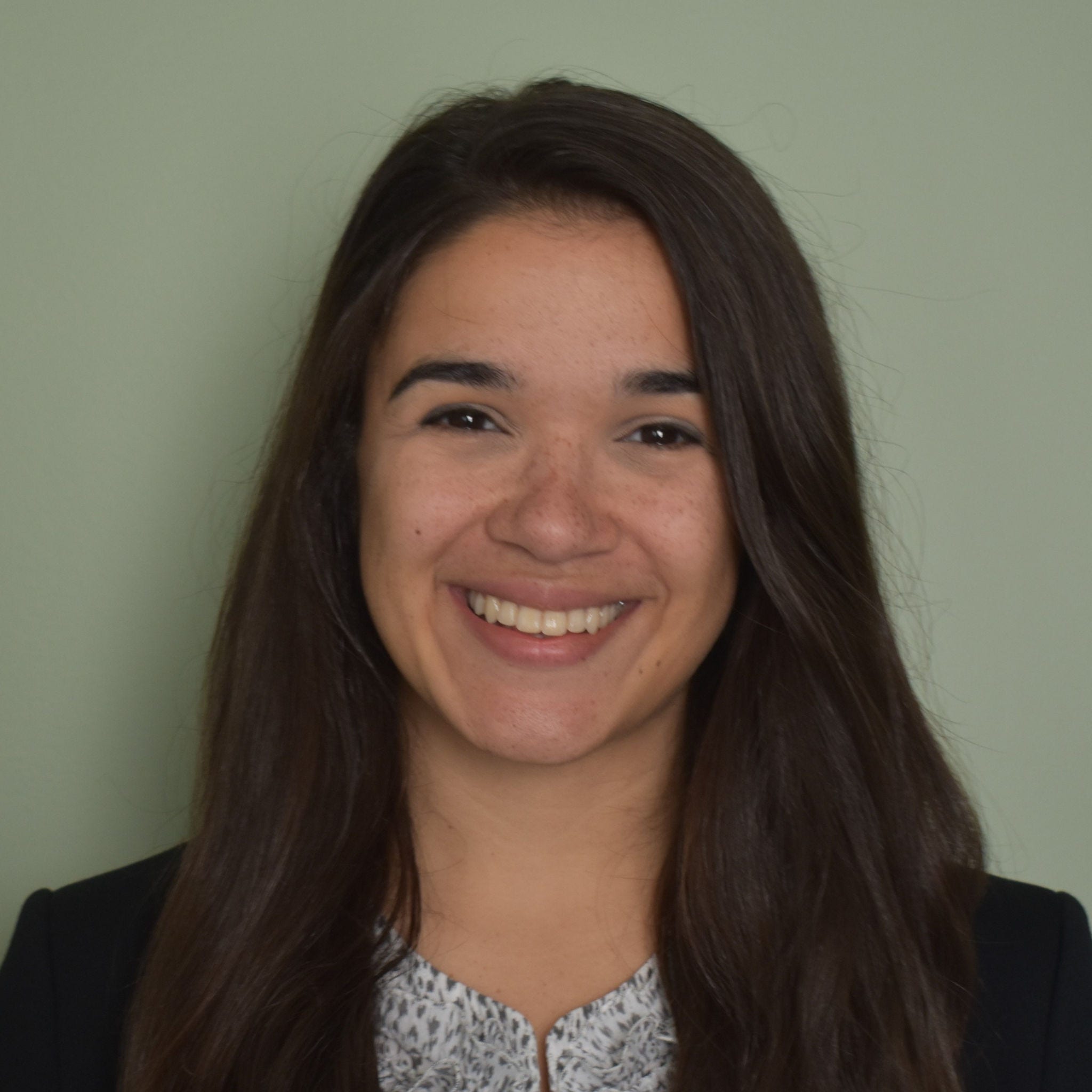Headshot of Kara Beck in a white and blue blouse and black blazer.