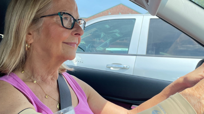 A photo of Julie Spangler, a volunteer driver for Road to Recovery, driving her car