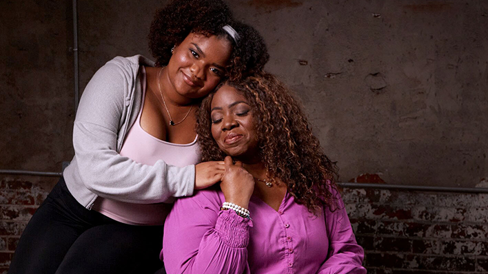 Two women wearing pink embracing each other