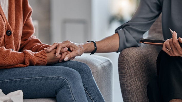 Woman Holding Hands in Therapist Office