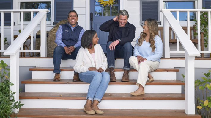 Dr. Arif Kamal and celebrity Patrick Dempsey sit on the front porch of a home as part of Pfizer's partnership with ACS to talk with others about disparities for those who live in rural communities with Change the Odds