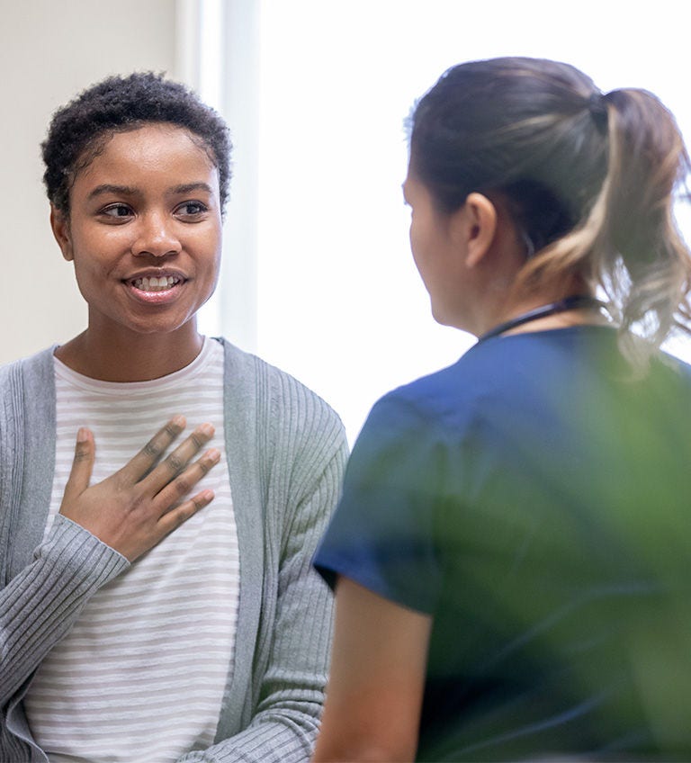 A woman engages in conversation with a nurse 