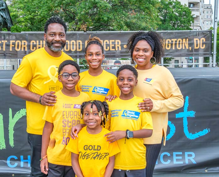 African american family posing for photo at cure fest event
