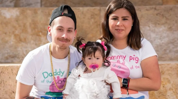 Chris Lopez, a colorectal cancer survivor, sits in a photo with his wife and daughter.