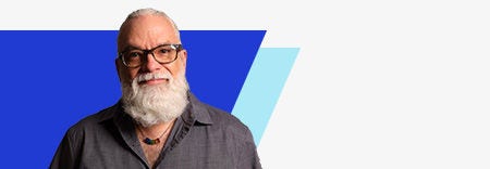 A bearded man(Steve) with glasses stands before a blue and white background