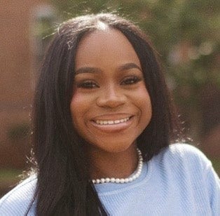 Headshot of Jaimyn Johnson, BS, in a baby blue sweater and pearl necklace